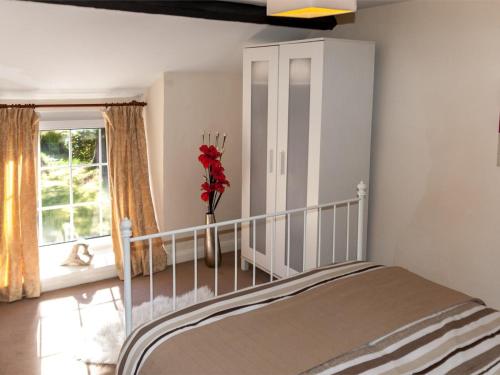 a bedroom with a bed and a large window at 2 Bed in Neath oc-bn247 in Crynant