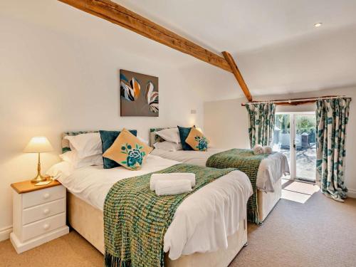 a bedroom with two beds and a window at 6 Bed in Bideford oc-thorn in Buckland Brewer