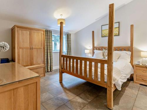 a bedroom with a wooden bed in a room at 2 Bed in Pontypool oc-58962 in Mamhilad