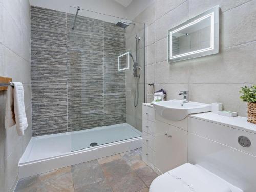a bathroom with a shower and a toilet and a sink at 2 Bed in Pontypool oc-58962 in Mamhilad
