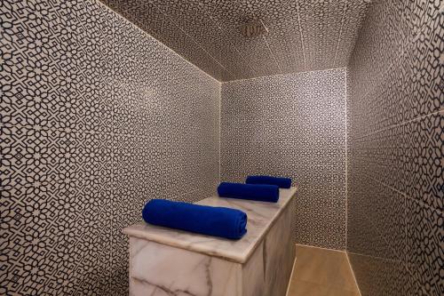 a bathroom with two blue pillows on a wall at Steigenberger Resort Achti in Luxor