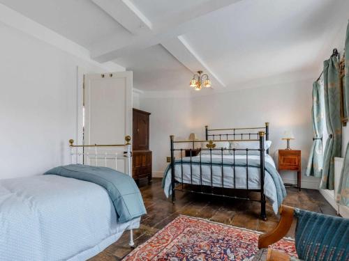 a bedroom with two twin beds and a rug at 3 Bed in Ludlow oc-82889 in Ludlow