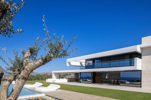 a modern house with a view of the ocean at Oliva D'oro Villa - Sunset Gaze by etouri in Chania