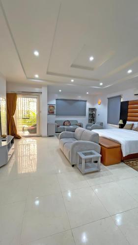 a large bedroom with a large bed and a couch at 3Apartments in Lagos
