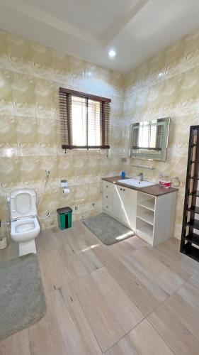 a bathroom with a toilet and a sink at 3Apartments in Lagos