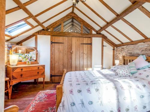 a bedroom with a bed and a wooden dresser at 1 Bed in Usk- oc-79936 in Llandenny