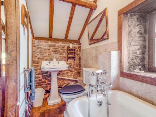 a bathroom with a toilet and a sink and a tub at 1 Bed in Usk- oc-79936 in Llandenny