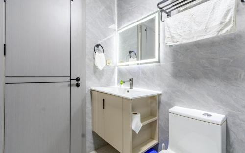 a white bathroom with a sink and a toilet at The Nestle & The Cradle - Kileleshwa in Nairobi