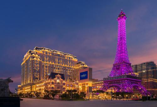 a purple christmas tree in front of a building at The Parisian Macao in Macau