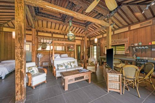 a bedroom with a bed and a couch and a table at Rancho Crescent Head in Crescent Head