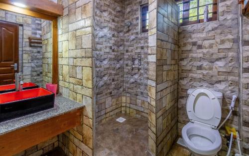 a bathroom with a toilet and a red sink at Savannah Bstan Luxury Apartment in Diani Beach