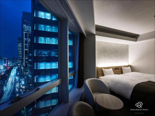 a hotel room with a view of a city at Daiwa Roynet Hotel Nagoya Eki Mae in Nagoya