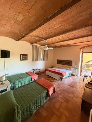 a room with two beds and a tv in it at Poggio Savelli in Scarperia