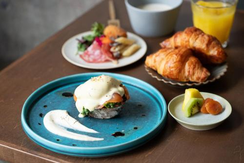a table topped with plates of food and pastries at Tokyu Stay Shibuya Ebisu in Tokyo