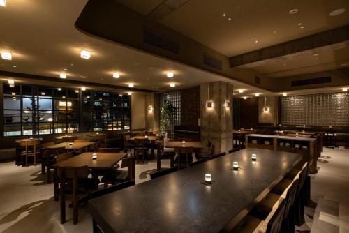 a restaurant with tables and chairs in a room at Tokyu Stay Shibuya Ebisu in Tokyo