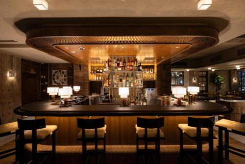 a bar in a restaurant with a lot ofools at Tokyu Stay Shibuya Ebisu in Tokyo