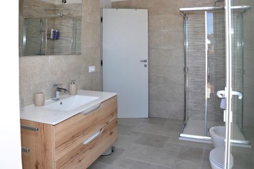 a bathroom with a sink and a shower at Villa Luce Relax by Perle di Puglia in Villa Castelli