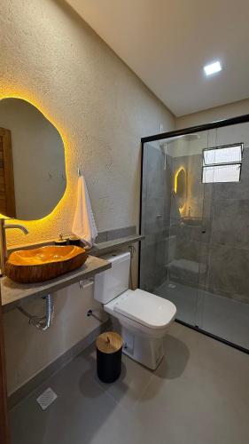a bathroom with a toilet and a glass shower at Pousada Verdes dos Corais in São Miguel dos Milagres