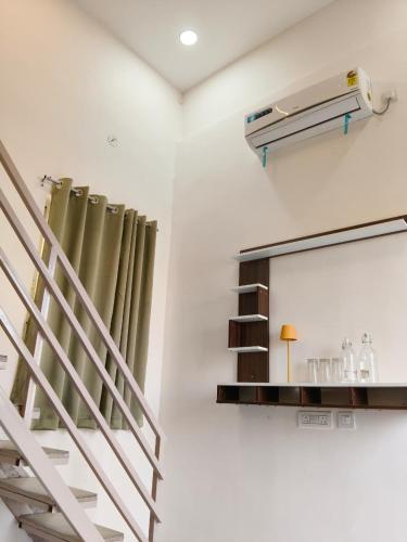 a staircase and a mirror in a room at Cherish Farm Stay in Medchal