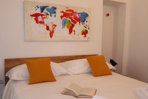 a bedroom with a bed with a book on it at Dimora San Giorgio in Bolsena in Bolsena