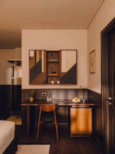 a kitchen with a table and a chair in a room at Aethos Hotel Milan in Milan