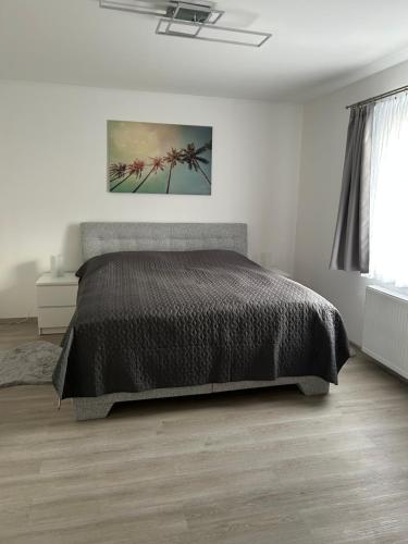 a bedroom with a bed with a black comforter at Na Písku in Most