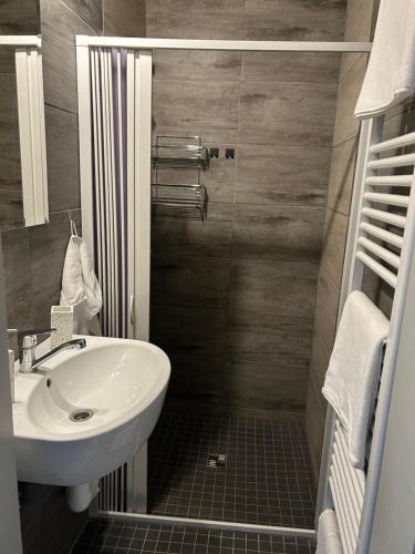 a bathroom with a white sink and a shower at Na Písku in Most