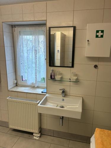 a bathroom with a sink and a window at Ferienwohnung Messerschmidt in Quedlinburg
