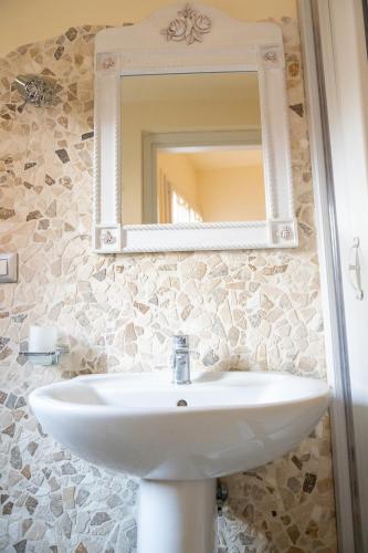 a bathroom with a sink and a mirror at Alloggio Turistico Porta di Poggio in Tuscania