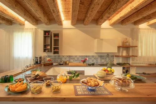 a kitchen with a table with fruits and vegetables on it at Agriturismo Relais Maddalene101 in Vicenza