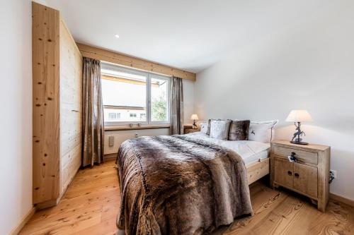 a bedroom with a large bed and a window at Belezza in Davos