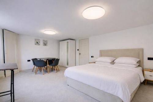 a bedroom with a bed and a table and chairs at Stylish 2BR Apartment in Leicester Square in London