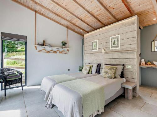 two beds in a bedroom with a wooden ceiling at 2 Bed in Llandrindod Wells oc-53193 in Llandrindod Wells