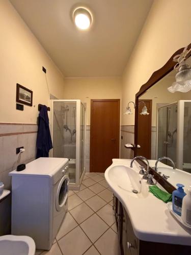 a bathroom with a tub and a sink and a shower at Guest House Colfiorito by Ospitaci in Colfiorito