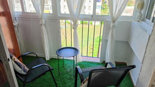 a group of chairs in a room with a window at Laguna Beach Paradise - Alojamientos La Torre in Torrox Costa