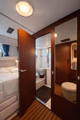 a small bathroom with a bed and a toilet at Sea Panther in Il-Gżira