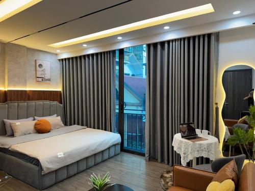 a bedroom with a bed and a large window at Dubai House in Hanoi