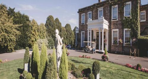a statue in a garden in front of a building at Ringwood Hall Hotel & Spa, Best Western Signature Collection in Chesterfield
