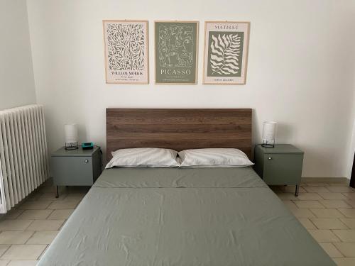 a bedroom with a large bed with two night stands at Casa Camilla in Lido di Fermo