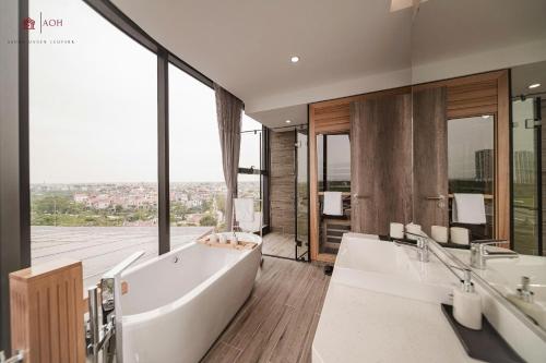 a large bathroom with two sinks and a tub at Maison de Ecopark - Onsen & Spa in Kim Quan