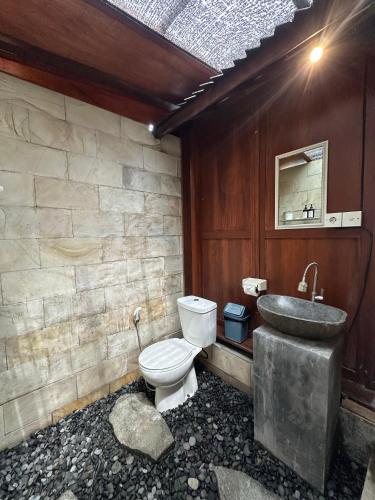 a bathroom with a toilet and a sink at Kelapa Sunrise Villa in Silebeng