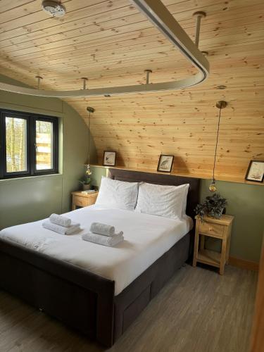 a large bed in a room with a wooden ceiling at Forbes of Kingennie in Dundee
