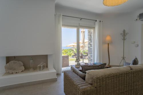 a living room with a couch and a large window at Chrysalis Nature Villa 9 in Kampos Paros