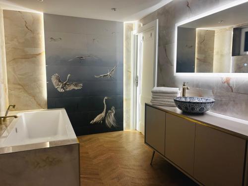 a bathroom with a sink and a bath tub at American Dream Villa in Łazory