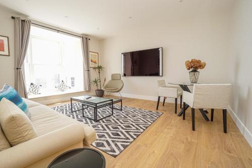 a living room with a couch and a table at 1 White Rock Heights in Hastings