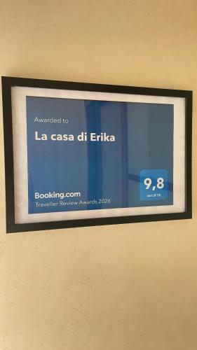 a framed sign on the wall of a building at La casa di Erika in Almè
