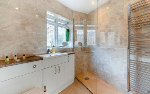 a bathroom with a sink and a shower at Lorash Cottage, Ashbourne in Ashbourne