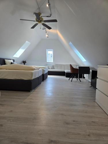 a bedroom with a bed and a ceiling fan at Loft Linda in Sylt