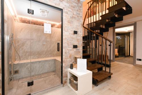 a glass shower in a room with a staircase at MGH Luxury- Romantic SPA & Relax in Poiano