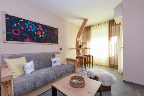 a living room with a couch and a table at MGH Luxury- Romantic SPA & Relax in Poiano